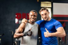 portrait-of-caucasian-sportsman-and-african-traine-5ZSKXY8