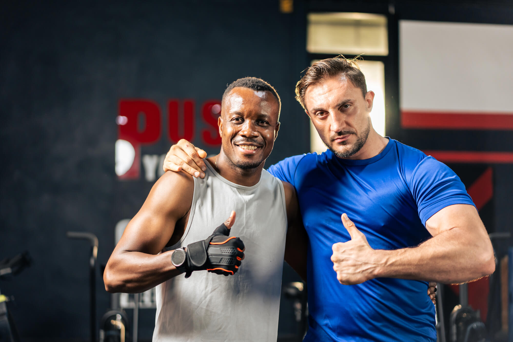 portrait-of-caucasian-sportsman-and-african-traine-5ZSKXY8